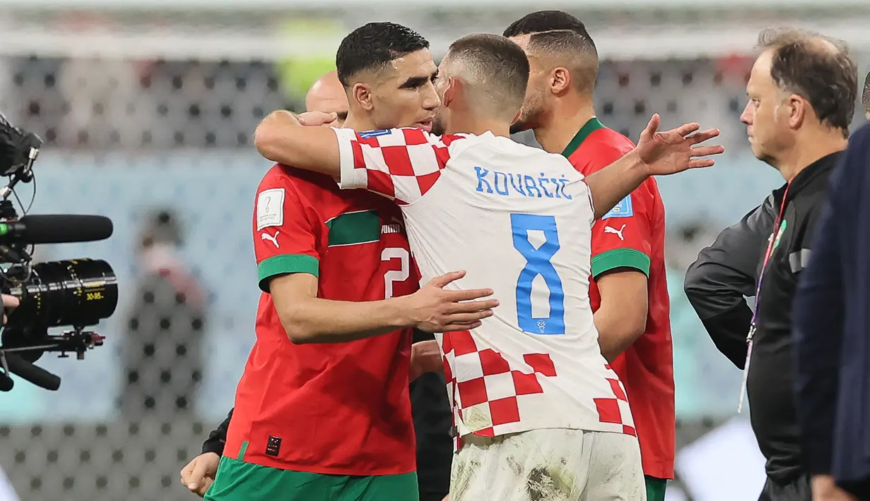 Bintang Maroko yang bermain untuk PSG, Achraf Hakimi pun berusaha dihibur oleh Mateo Kovacic, yang seakan memberi semangat dan mengakui perjalanan hebat Timnas Maroko di Piala Dunia 2022. (AFP/Karim Jaafar)