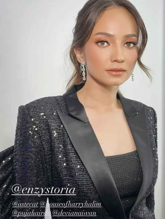 Makeup-nya dibuat tone down dengan soft glam look bernuansa cokelat nude di mata dan bibir [@enzystoria]