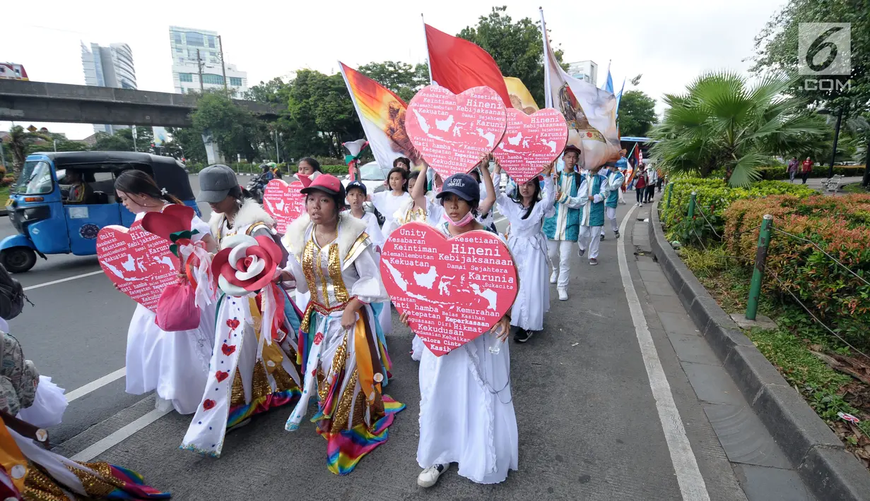 Sejumlah umat Kristiani membawa lambang hati saat kirab perayaan Paskah di sekitar Jalan Medan Merdeka Selatan, Jakarta, Minggu (4/1). Kirab dimulai dari Bundaran Hotel Indonesia dan berakhir di gereja Immanuel Jakarta. (Liputan6.com/Helmi Fithriansyah)