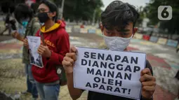 Massa yang tergabung dalam Aliansi Menolak Lupa menggelar aksi damai di kawasan Tugu Proklamasi, Jakarta, Kamis (15/10/2020). Dalam aksinya, mereka mengecam represifitas aparat kepolisian terhadap massa aksi, medis, jurnalis, dan masyarakat sipil lainnya. (Liputan6.com/Faizal Fanani)