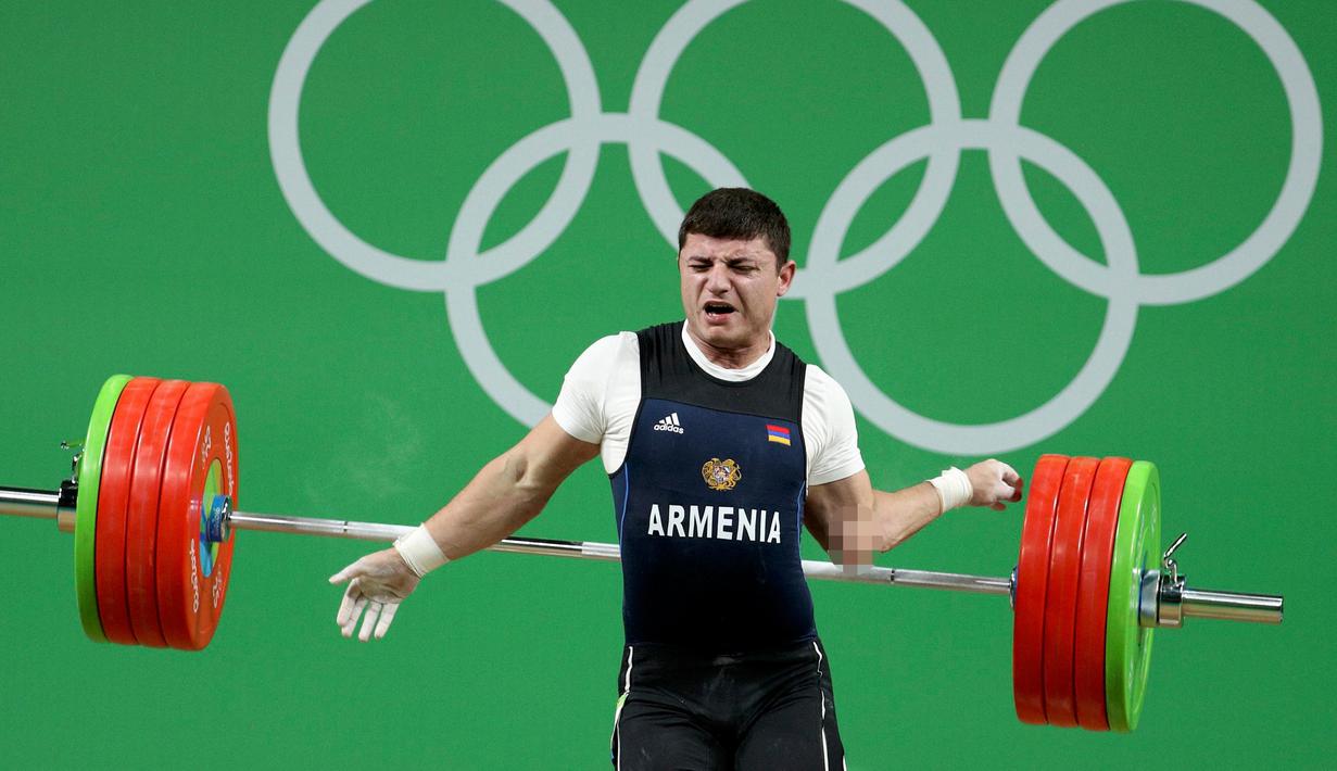 Atlet angkat besi Armenia, Andranik Karapetyan mengalami cedera horor ketika tampil di nomor 77 kg putra pada Olimpiade 2016 di Rio de Janeiro, Rabu (10/8). Siku Karapetyan patah saat hendak mengangkat beban 195 kilogram. (REUTERS/Stoyan Nenov)