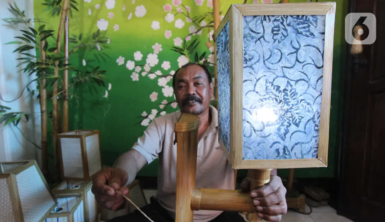 Perajin lampion hias, Nana Suryana (52), menyelesaikan pesanan konsumen di kawasan Benda, Kota Tangerang. Selasa (9/3/2021). Hasil karya tersebut semuanya menggunakan limbah yang didapat dari daerah sekitar lingkungan kampungnya. (Liputan6.com/Angga Yuniar