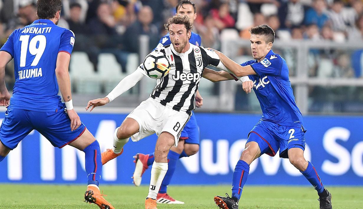 Pemain Juventus, Claudio Marchisio (tengah)  berebut bola dengan pemain Bologna, Adam Nagy pada lanjutan Serie A di Allianz Stadium, Turin, (5/5/2018). Juventus menang 3-1. (Alessandro Di Marco/ANSA via AP)