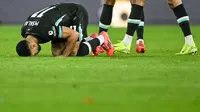 Pemain Liverpool, Mohamed Salah (bersujud), melakukan selebrasi setelah mencetak gol ke gawang Southampton pada matchday 12 Liga Inggris 2024/2025 di St. Mary's Stadium, Minggu (24/11/2024) malam WIB. (JUSTIN TALLIS / AFP)