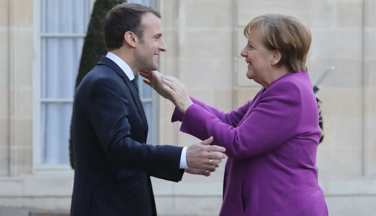 Presiden Prancis Emmanuel Macron (kiri) menyambut Kanselir Jerman Angela Merkel saat tiba di Istana Presiden Eylsee di Paris (16/3). Pertemuan tersebut untuk membahas reformasi Uni Eropa. (AFP Photo/Ludovic Marin)