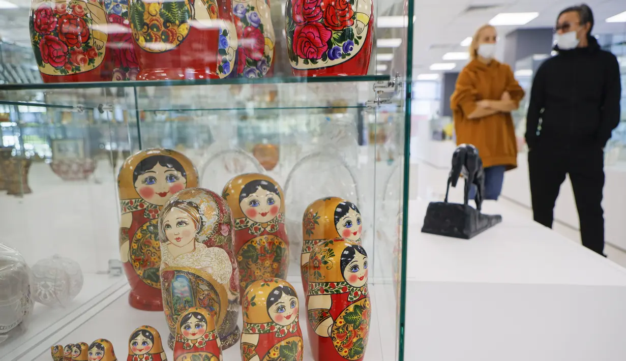 Orang-orang yang memakai masker mengunjungi pameran kesenian rakyat tradisional Rusia di Moskow, Rusia, 4 Oktober 2020. Lebih dari 1.000 karya seni tradisional Rusia buatan produsen kerajinan terkemuka dipamerkan di acara tersebut. (Xinhua/Alexander Zemlianichenko Jr)