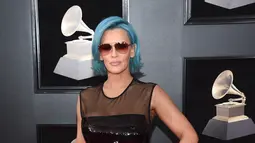 Aktris sekaligus model, Jenny McCarthy berpose di karpet merah Grammy Awards 2018, New York, Minggu (28/1). Penampilan tak istimewa Jenny McCarthy mengenakan gaun berbahan PVC yang mengilap, kacamata hitam berikut wig biru. (Evan Agostini/Invision/AP)