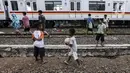 Anak-anak bermain bola di tengah perlintasan kereta api kawasan Ancol, Jakarta Utara, Kamis (19/5/2022). Dari 14 kasus dugaan hepatitis akut terdapat 6 kasus meninggal dunia, 4 kasus masih dirawat, dan 4 kasus sudah dipulangkan. (Liputan6.com/Johan Tallo)