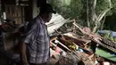 Seorang warga berjalan di rumahnya yang rusak parah akibat gempa bumi di Huizontla, negara bagian Michoacan, Meksiko, Selasa (20/9/2022). Sebagian besar kerusakan terjadi di negara-negara Pasifik, dekat dengan pusat gempa Michoacan. (AP Photo/Armando Solis)