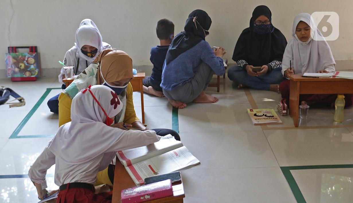 Sejumlah siswa belajar di Aula Kelurahan Jatirahayu, Bekasi, Jawa Barat, Rabu (29/7/2020). Pemerintah Kota Bekasi melalui Kelurahan Jatirahayu menyediakan fasilitas wifi gratis bagi siswa yang terkendala kuota internet dalam kegiatan belajar secara daring. (Liputan6.com/Herman Zakharia)