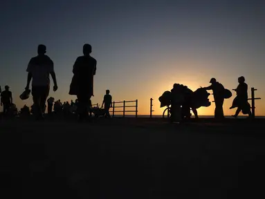 Pengungsi Palestina yang terpaksa mengungsi kembali bergerak menuju wilayah selatan di sepanjang jalan di kawasan kamp pengungsi Nuseirat di Jalur Gaza tengah pada 20 September 2025. (Eyad BABA/AFP)