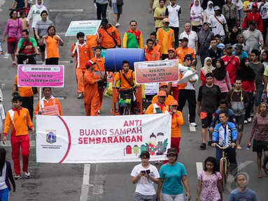Sejumlah orang yang tergabung dari Dinas Kebersihan Jakarta menggelar aksi damai di Bundaran HI, Minggu (28/12/2014). (Liputan6.com/Faizal Fanani)