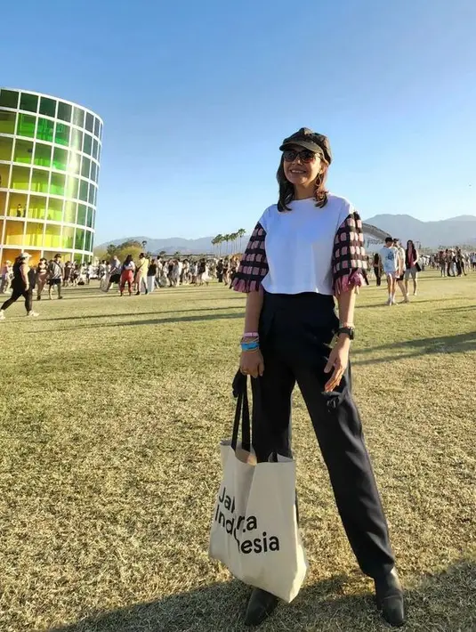 <p>Di hari berikutnya, Najwa memamerkan gaya casualnya dengan memadukan blouse, celana panjang, sepatu hitam,  topi, dan tote bag. (Instagram/najwashihab).</p>