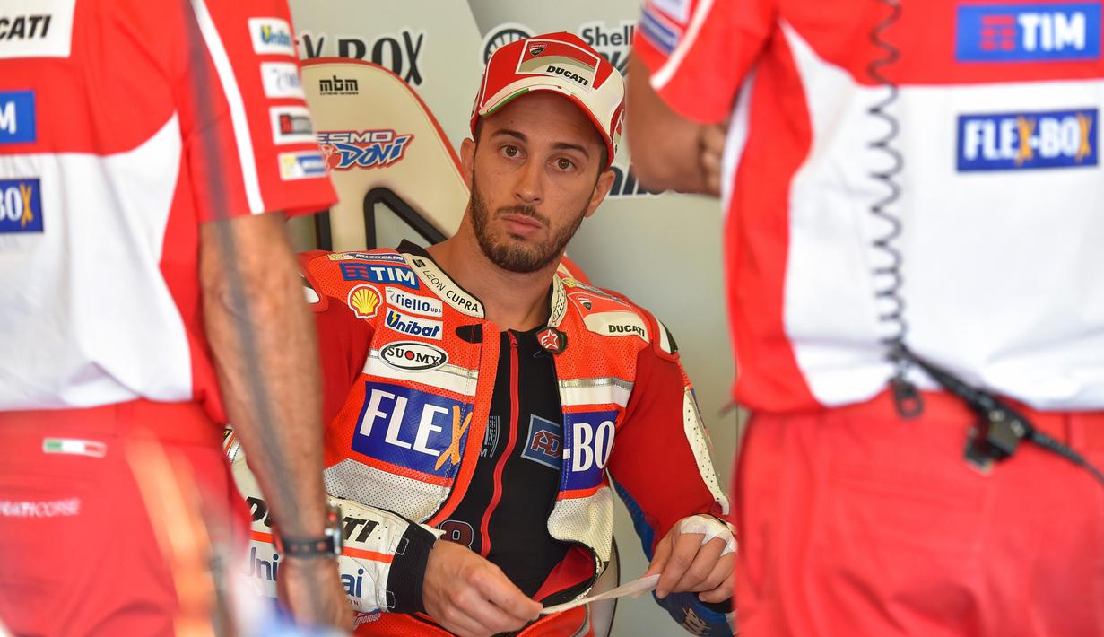 Pebalap Ducati, Andrea Dovizioso saat berdiskusi dengan tim mekanik sebelum melakukan sesi latihan bebas pada balapan San Marino Moto GP Grand Prix di Marco Simoncelli Circuit, Misano (9/9/2017). (AFP/Andreas Solaro)
