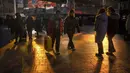 Pengunjung diterangi oleh pantulan sinar matahari saat mereka berjalan melalui pusat perbelanjaan pada hari terakhir minggu liburan Tahun Baru Imlek di Beijing, Jumat, 27 Januari 2023. (AP Photo/Mark Schiefelbein)