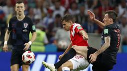 Bek Rusia, Roman Zobnin, berebut bola dengan striker Kroasia, Mario Mandzukic, pada laga perempat final Piala Dunia di Stadion Fisht, Sochi, Sabtu (7/7/2018). Kroasia menang 2-2 (4-3) atas Rusia. (AP/Rebecca Blackwell)