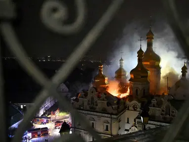 Asap dan api membubung dari Katedral Dormition, kompleks Ortodoks Kyiv Pechersk Lavra setelah serangan rudal Rusia di ibu kota Ukraina, Kyiv, Senin 15 Juni 2026, di tengah invasi Rusia. (Genya Savilov/AFP)