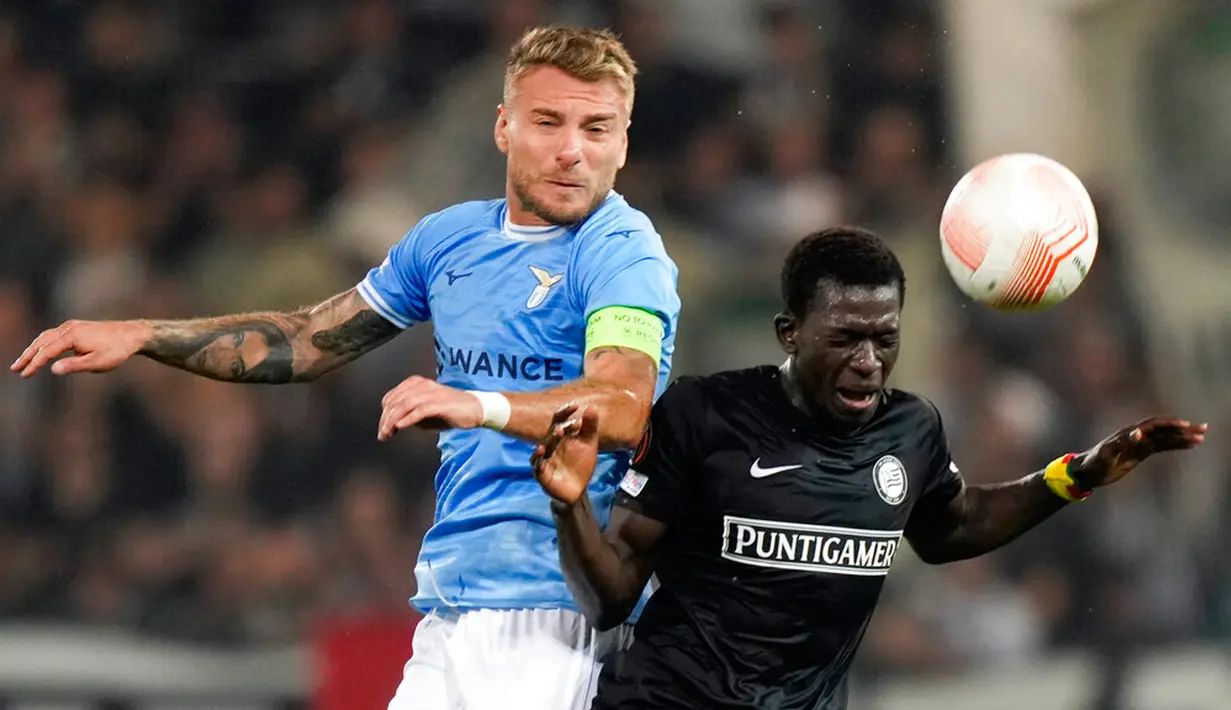 Pemain Lazio Ciro Immobile (kiri) berebut bola dengan pemain Sturm Graz Amadou Dante pada pertandingan sepak bola Grup F Liga Europa di Merkur Arena, Graz, Austria, 6 Oktober 2022. Pertandingan berakhir imbang 0-0. (AP Photo/Florian Schroetter)
