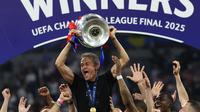 Luis Enrique angkat trofi Liga Champions usai anak asuhnya PSG mengalahkan Inter Milan dengan skor 5-0. (FRANCK FIFE / AFP)