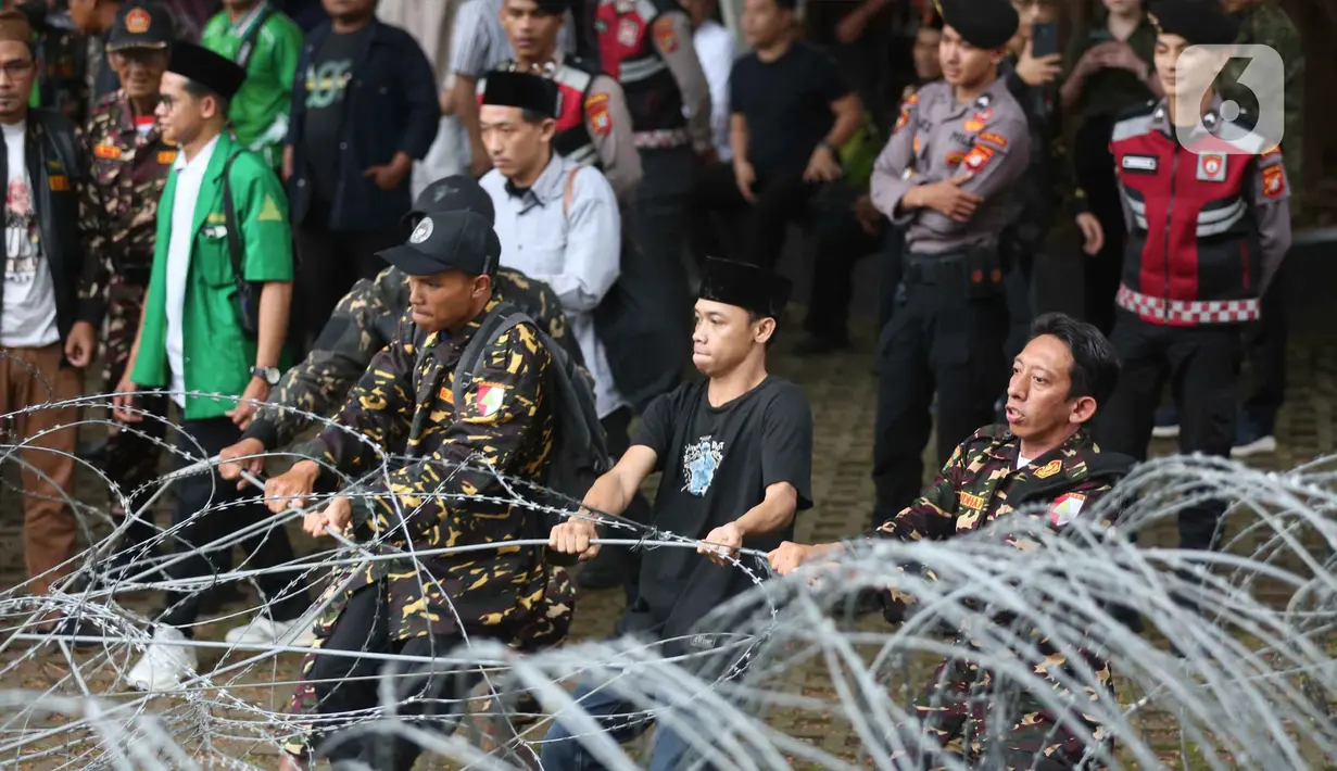 Untuk diketahui, Yaqut Cholil Qoumas merupakan tersangka dugaan tindak pidana korupsi terkait kuota haji untuk penyelenggaraan ibadah haji Indonesia tahun 2023-2024. Tampak dalam foto, anggota dan simpatisan Barisan Ansor Serbaguna (Banser) saat berunjuk rasa di depan gedung Merah Putih Komisi Pemberantasan Korupsi (KPK), Jakarta, Kamis (12/3/2026). (Liputan6.com/Helmi Fithriansyah)
