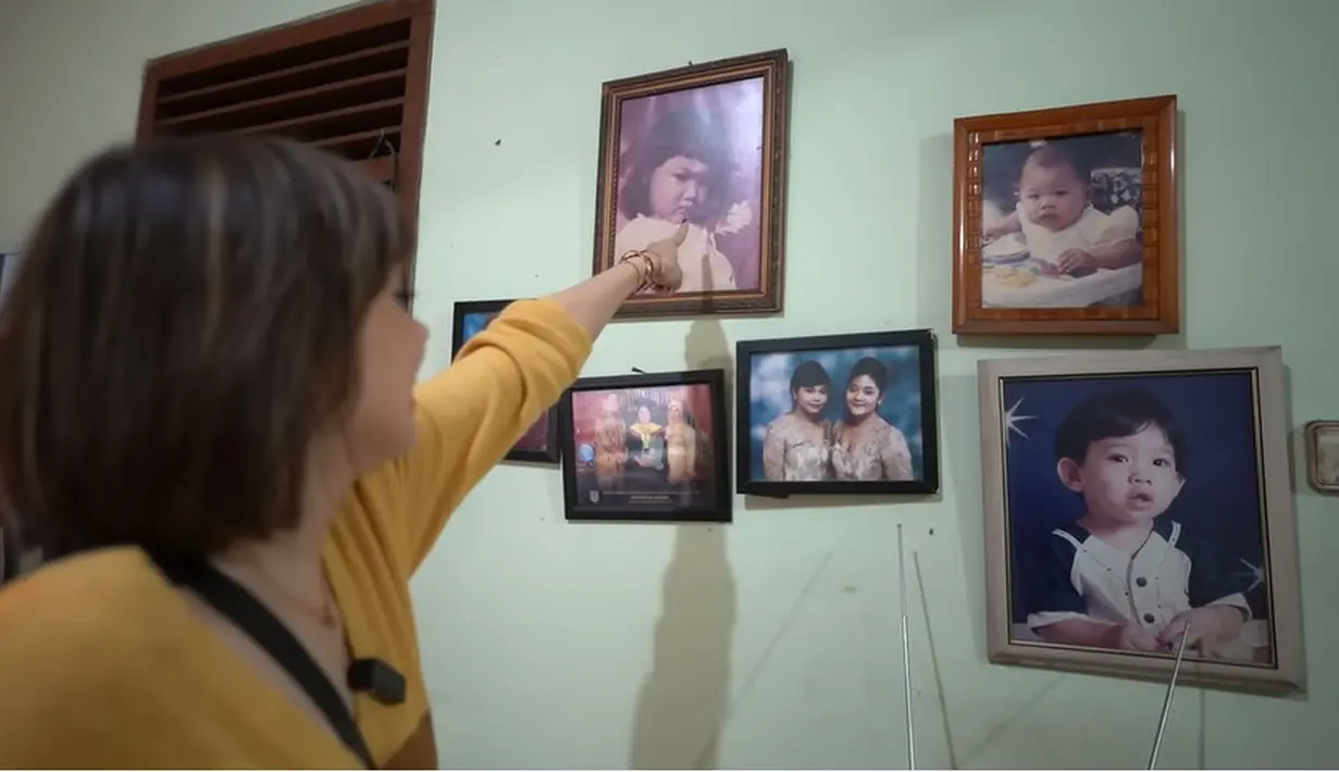 Sarah dan Wisnu menyebut tampilan dan interior rumahnya tidak banyak yang berubah. Sara menunjuk potret masa kecilnya yang masih terpampang. [Youtube/Sara Wijayanto]