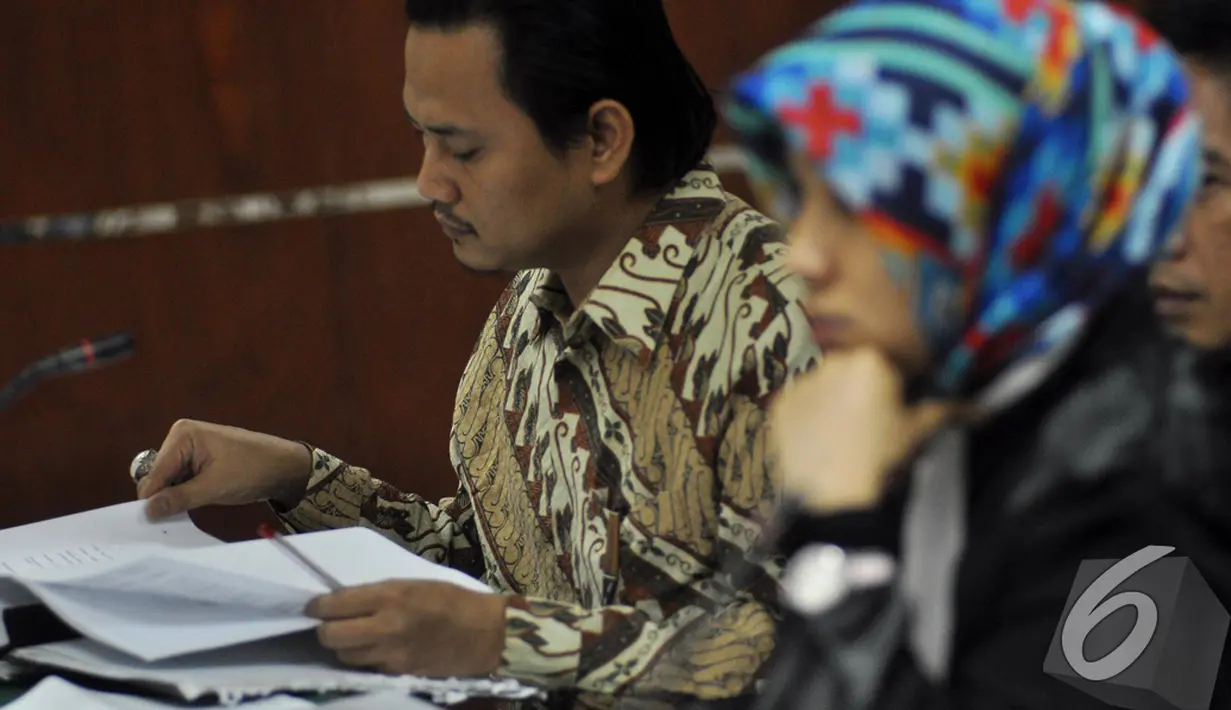 Saat saksi memberikan keterangan, anak mantan Menteri Syarief Hasan, Riefan Avrian, terlihat serius membaca berkas yang berada di hadapannya, Jakarta, Kamis (30/10/2014). (Liputan6.com/Miftahul Hayat)