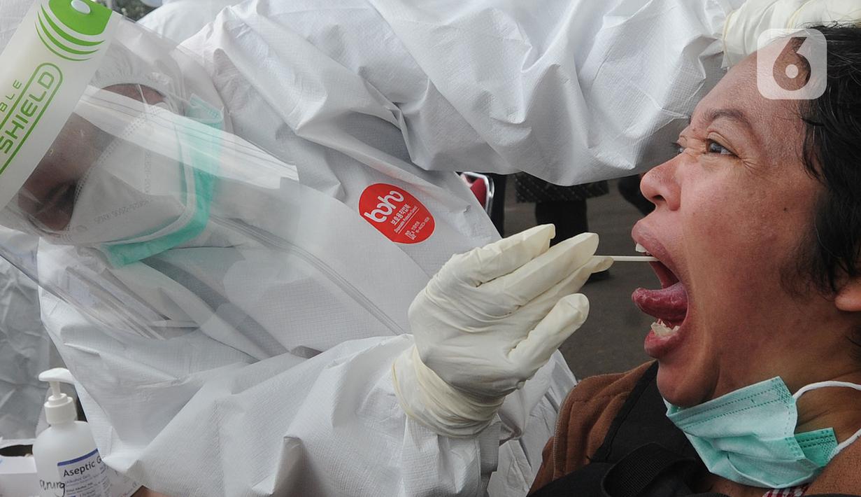 Paramedis mengambil sampel penumpang KRL Commuter Line saat tes swab di Stasiun Bojonggeder, Jawa Barat, Senin (11/05/2020).  Tes swab dan rapid dilakaukan sebagai salah satu metode untuk mendeteksi dan mencegah penyebaran Covid-19 di moda transportasi KRL Commuter Line. (merdeka.com/Arie Basuki)