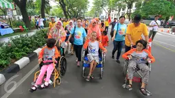 Anak-anak disabilitias mengikuti jalan sehat dalam acara Jalan Sehat Keluarga Disabilitas (JSKD) di Pasar Akhir Pekan SCBD, Jakarta (11/12). Kegiatan tersebut dalam rangka memperingati Hari Disabilitas Internasional.(Liputan6.com/Fery Pradolo)