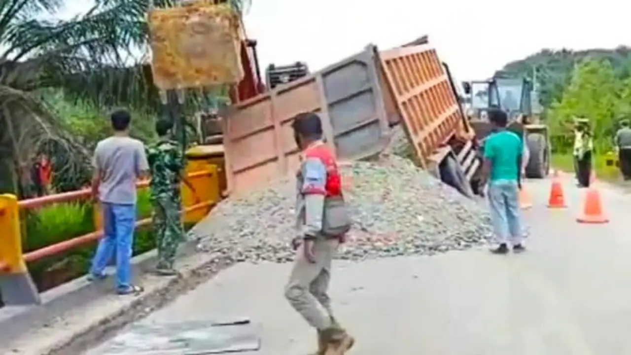 Truk terperosok akibat jembatan ambles di Palalawan dan menyebabkan akses jalan Pekanbaru-Pangkalan Kerinci Putus. (Foto: Liputan6.com/tangkapan layar/Syukur)
