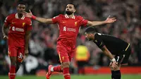 Mohamed Salah pada menit ke-75 berhasil menambah keunggulan Liverpool. Kemenangan atas atas Bologna mengantar Liverpool bertengger di lima besar klasemen Liga Champions 2024/2025. (Paul ELLIS/AFP)