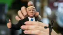 Pekerja membetulkan kepala boneka Presiden AS Donald Trump saat pidato di toko mainan, Hong Kong (3/2). (AFP Photo/Anthony Wallace)