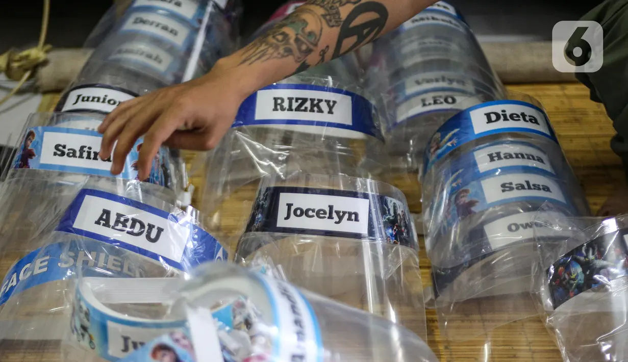 Bucek merapikan face shield di workshopnya di kawasan Bekasi, Jawa Barat, Rabu (3/6/2020). Pemerintah mewajibkan petugas pelayanan, pedagang, serta pekerja toko swalayan dan mal mengenakan face shield saat fase new normal diterapkan. (Liputan6.com/Faizal Fanani)