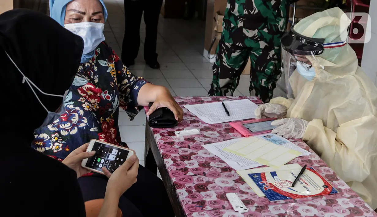 Warga melakukan tes cepat (rapid test) massal Covid-19 di SDN Petamburan 01, Petamburan, Jakakrta, Jumat (27/11/2020). Rapid Test massal tersebut digelar kembali karena sebelumnya masih banyaknya warga yang tidak mau ikut karena merasa takut. (Liputan6.com/Johan Tallo)