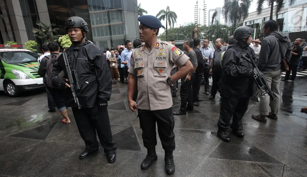 Petugas kepolisian bersenjata berjaga di sekitar lokasi Gedung BEI, Jakarta, Senin (15/1). Demi keamanan dan keselamatan, pihak keamanan menutup area sekitar lokasi gedung BEI yang ambruk. (Liputan6.com/Arya Manggala)