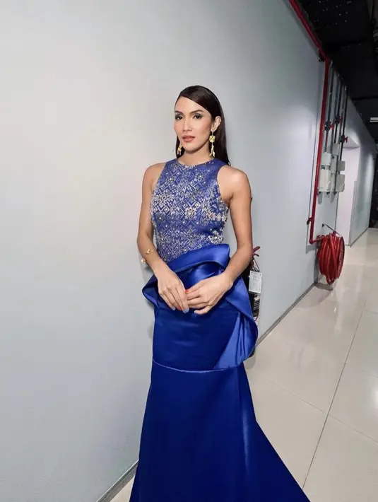 Aulia Sarah mengenakan gaun biru dengan atasan halter neck dan bermotif songket dari Yosep Sinudarsono, serta rok biru polos berlayer di bagian pinggang. @fer.nandodiaz