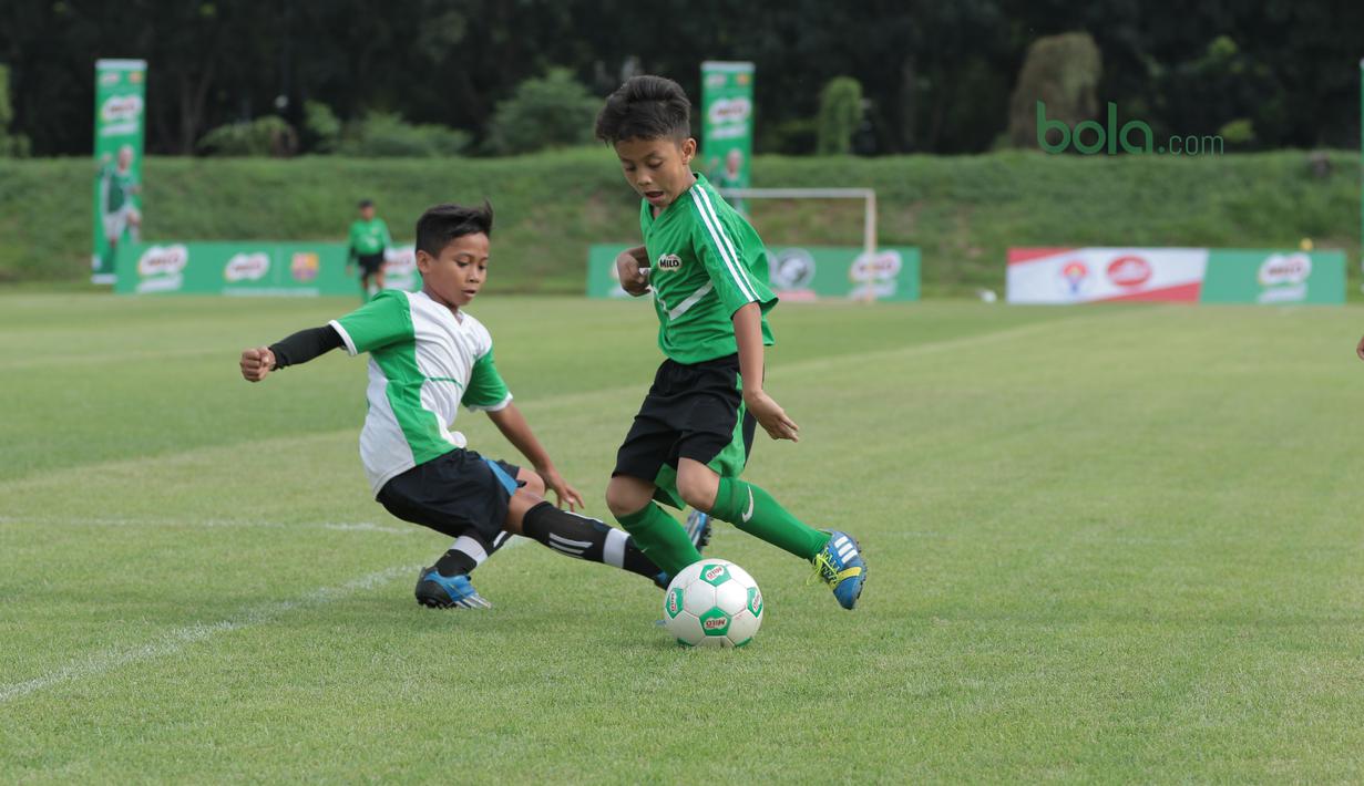 Duel dua pesepak bola cilik pada ajang MILO Football Championship 2018 di Lapangan Panahan GBK, Jakarta, (24/3/2018). Sekitar 128 Sekolah Dasar di Jakarta ikut ambil bagian pada ajang tersebut. (Bola.com/Nick Hanoatubun)