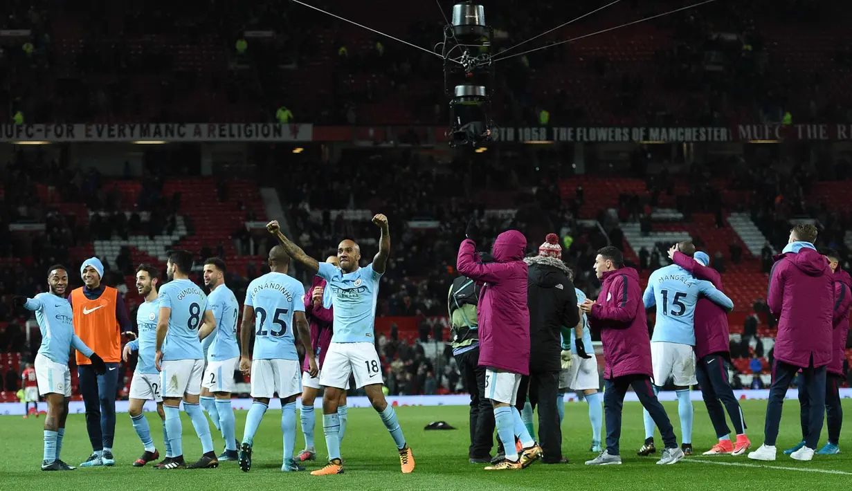 Para pemain Manchester City merayakan kemenangan usai pertandingan melawan Manchester United pada Liga Inggris di Old Trafford Stadium, Inggris, (10/12). City menang atas MU 2-1. (AFP Photo/Oli Scarff)