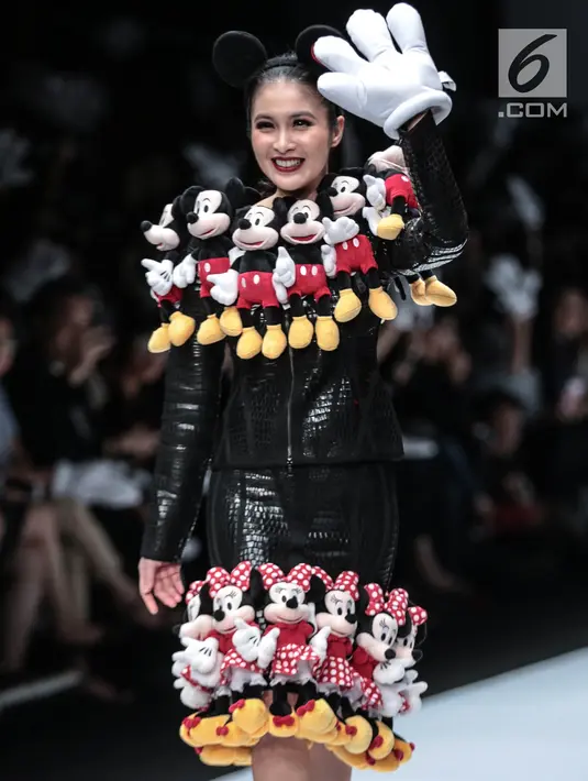 Artis Sandra Dewi mengenakan busana kolaborasi antara Disney dan Matahari pada Jakarta Fashion Week 2019 di Senayan City, Selasa (23/10). Dalam penampilannya, Sandra Dewi mengenakan busana dengan ornamen boneka Mickey Mouse. (Liputan6.com/Faizal Fanani)