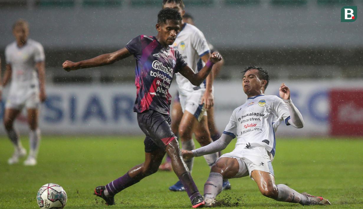 Pemain Rans Cilegon FC, Jujun Junaedi (kiri) berebut bola dengan pemain PSIM Yogyakarta, Yoga Pratama dalam laga semifinal Liga 2 2021 di Stadion Pakansari, Bogor, Senin (27/12/2021). (Bola.com/Bagaskara Lazuardi)
