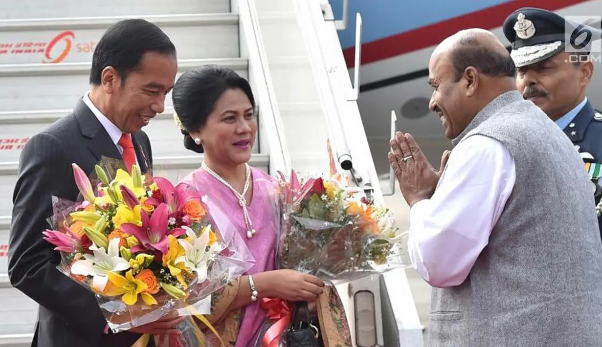 Presiden Joko Widodo dan Ibu Negara Iriana Joko Widodo disambut Kepala Protokol Negara India, Sanjay Verma di Pangkalan Udara Palam, New Delhi (25/1). (Liputan6.com/Pool/Biro Pers Setpres)
