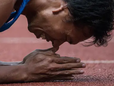 Atlet Jawa Tengah, Ega Rizki Firmanto, melakukan selebrasi usai memenangi nomor 200 meter T +54 putra pada Peparnas XV di Stadion Gelora Bandung Lautan Api, Bandung, Kamis (20/10/2016). (Bola.com/Peksi Cahyo) 