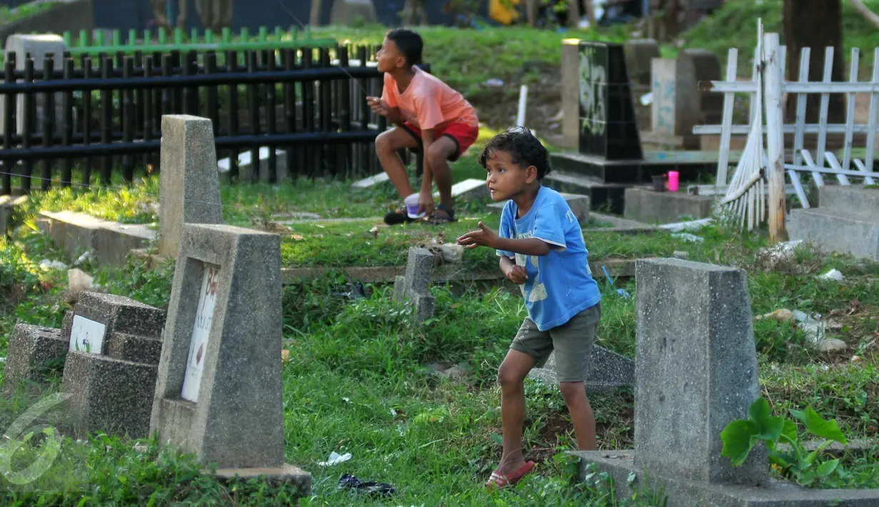 Seorang bocah bermain layang-layang di TPU Menteng Atas, Jakarta, Rabu (8/6). RPTRA dan TPA dibangun dengan tujuan agar anak-anak dapat bermain dan belajar di tempat yang layak. (Liputan6.com/Gempur M Surya)
