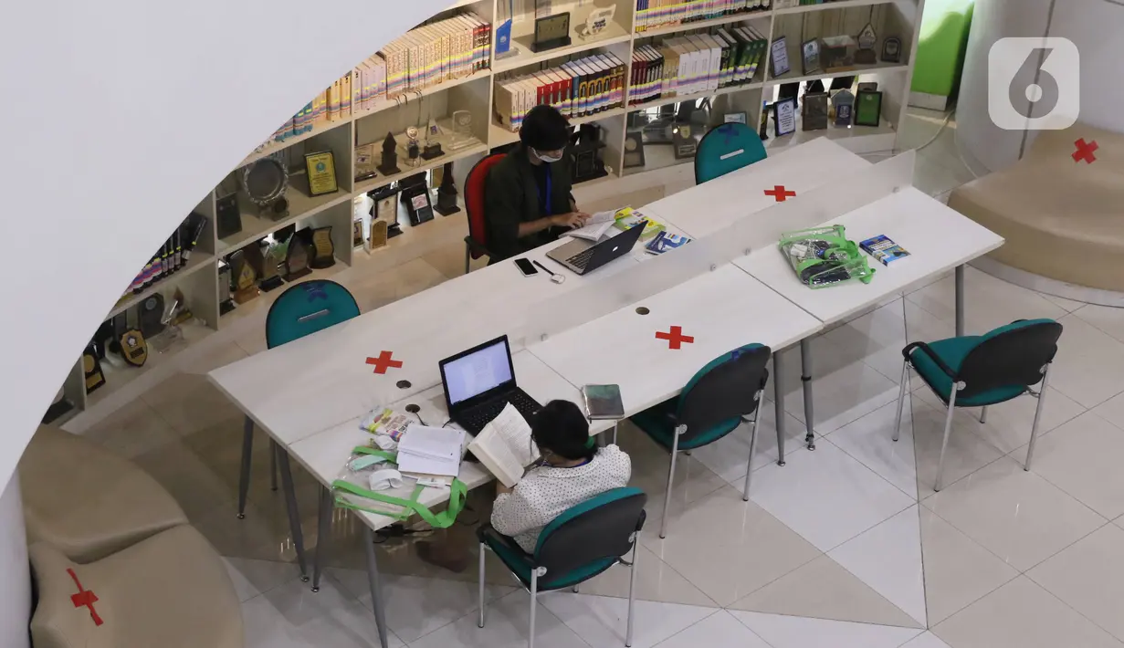 Pengunjung membaca buku di Perpustakaan Nasional (Perpusnas), Jakarta, Kamis (10/6/2020). Perpusnas membuka kembali membuka pelayanan mulai Kamis ini, 11 Juni 2020, dengan menyiapkan protokol kesehatan setelah beberapa bulan tutup akibat COVID-19. (Liputan6.com/Angga Yuniar)