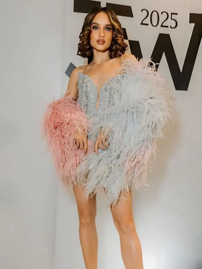Cinta Laura Kenakan Gaun Mini Dipadukan Selendang Bulu di JFW 2025