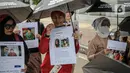 Sejumlah pekerja rumah tangga (PRT) menggelar aksi di depan Taman Aspirasi Monas, Jakarta, Rabu (21/12/2022). Aksi tersebut dilakukan untuk memperingati Hari Ibu serta meminta pemerintah untuk mengesahkan Rancangan Undang-Undang Perlindungan Pekerja Rumah Tangga (RUU PPRT). (Liputan6.com/Faizal Fanani)