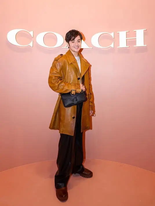 Angga melengkapi tampilannya dengan ini Soft Tabby Multi Crossbody In Signature Leather dalam warna hitam. [Foto: Dok. Coach]