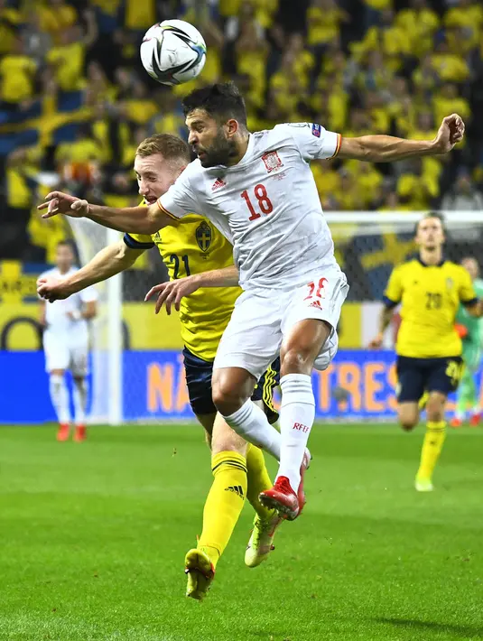Pemain Spanyol Jordi Alba (atas) berebut bola dengan pemain Swedia Dejan Kulusevsk pada pertandingan Grup B kualifikasi Piala Dunia 2022 di Friends Arena, Stockholm, Swedia, Kamis (2/9/2021). Swedia menang 2-1. (Claudio Bresciani/TT News Agency via AP)
