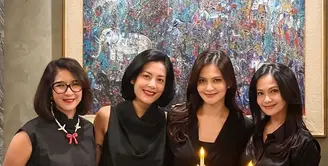 Novita Angie hadir mengenakan kemeja sleeveless hitam dipadukan celana panjang warna serasi. Tampilannya dilengkapi dengan kalung mutiara dengan liontin pita. [@cuttaryofficial]