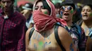 Seorang wanita bertelanjang dada menggelar aksi mogok nasional di Bogota, Kolombia, (17/3). Mereka menuntut pemerintah agar meningkatkan layanan kesehatan bagi warga. (AFP/Guillermo LEGARIA)