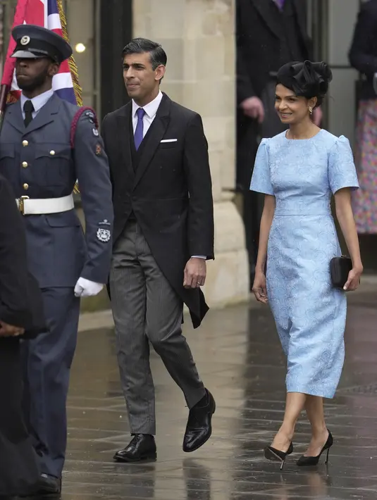 Perdana Menteri Inggris Rishi Sunak dan istrinya Akshata Murthy tiba di Westminster Abbey menjelang penobatan Raja Charles III dan Permaisuri Camilla di London, Sabtu, 6 Mei 2023. (AP Photo/Kin Cheung)